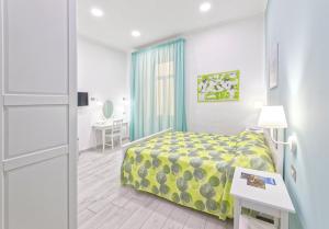 a hotel room with a bed and a table and a desk at B&B Rest a Napoli in Naples