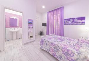 a bedroom with a bed and a sink and a mirror at B&B Rest a Napoli in Naples