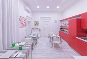 a dining room with tables and chairs and red cabinets at B&B Rest a Napoli in Naples +23 photos