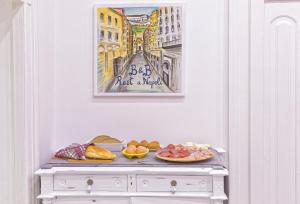 a table with plates of food on top of it at B&B Rest a Napoli in Naples