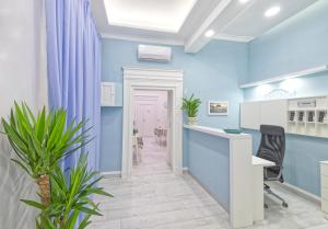a blue room with a desk and chairs at B&B Rest a Napoli in Naples