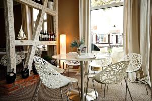 a table and chairs in a room with a window at Residence Puro Beach - Adults only in Międzyzdroje