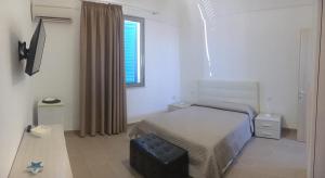 A bed or beds in a room at Porto Gaio Accomodation