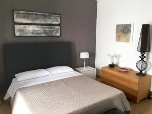 A bed or beds in a room at Porto Gaio Accomodation