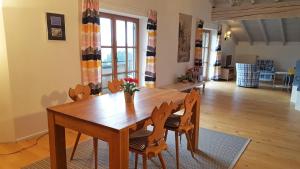 a dining room with a wooden table and chairs at Jungholz Erlebnis in Jungholz