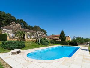 a swimming pool in the yard of a house at Beautiful holiday home with nature views in Villefranche-du-Périgord