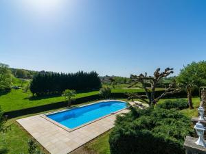 an image of a swimming pool in a garden at Beautiful holiday home with nature views in Villefranche-du-Périgord