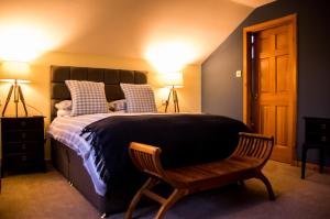 a bedroom with a bed and a chair and lights at Davar in Lochinver