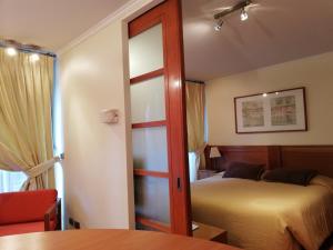 Tempat tidur dalam kamar di Andes Suites