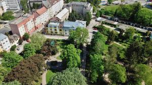 an overhead view of a city with buildings and trees at Old Town Loft in Žilina