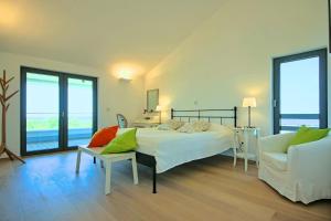 a bedroom with a bed and a couch and a chair at Villa Bianca in Svetvinčenat +33 photos