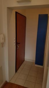 an empty room with a door and a tile floor at Veki's house in Skopje