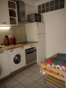 a kitchen with a washing machine and a refrigerator at Vieille Ville 2 - La Petite Maison à Safranier, 2 bedrooms, max 4 adults and 2 kids in Antibes