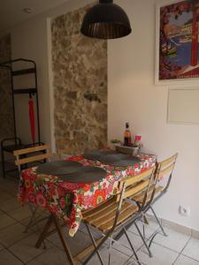 a table with a table cloth on it in a room at Vieille Ville 2 - La Petite Maison à Safranier, 2 bedrooms, max 4 adults and 2 kids in Antibes