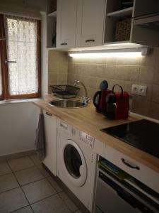 a kitchen with a washing machine and a sink at Vieille Ville 2 - La Petite Maison à Safranier, 2 bedrooms, max 4 adults and 2 kids in Antibes