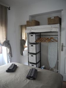 a bedroom with a bed with two black shoes on it at Vieille Ville 2 - La Petite Maison à Safranier, 2 bedrooms, max 4 adults and 2 kids in Antibes