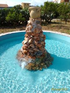 a rock christmas tree in a swimming pool at B&B L'Uliveto in Marina di Schiavonea