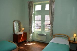 a bedroom with a bed and a window and a mirror at Château de Rys in Bossay-sur-Claise