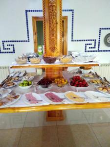 a table filled with different types of food at Malika Prime Hotel in Samarkand