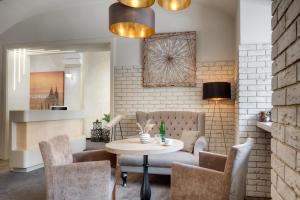 a living room with a table and chairs at Hotel Florenc in Prague +33 photos