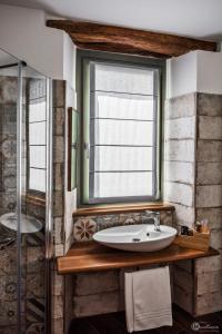 a bathroom with a sink and a window at Albergo del Bramante in Roccaverano