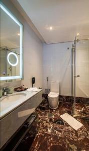 a bathroom with a toilet and a sink and a shower at Braira Al Wezarat in Riyadh