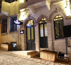 a building with two doors and a sign on it at Calanthe Residence in Istanbul