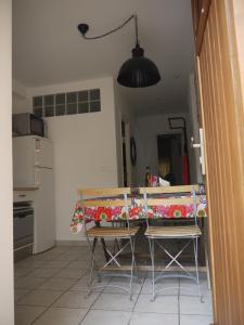 a kitchen with a table with a table cloth on it at Vieille Ville 2 - La Petite Maison à Safranier, 2 bedrooms, max 4 adults and 2 kids in Antibes