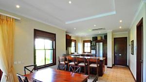 a kitchen and dining room with a table and chairs at Eden Island, Beach front, Luxury, 3 Bed Ensuite, WiFi in Eden Island