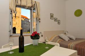 a bedroom with a bed and a table with wine glasses at Apartment Punat in Korčula