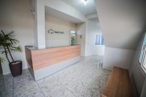 an office lobby with a reception desk and a plant at Hotel Cielo in Porto Velho