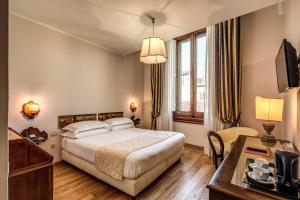 Postel nebo postele na pokoji v ubytování Hotel Croce Di Malta