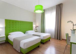 En eller flere senge i et værelse på Hotel Milano Palmanova