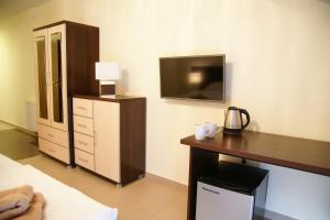 a bedroom with a desk and a tv on the wall at Willa Cztery Brzozy Chałupy in Chałupy +32 photos