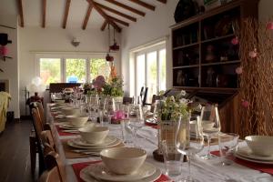 a long table with glasses and plates on it at Quinta da Sardinha in Elvas