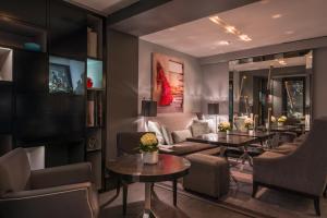 a living room with couches and tables at Les Jardins De La Villa in Paris