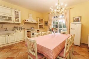 a kitchen with a table and chairs and a refrigerator at Nebo in Zagreb