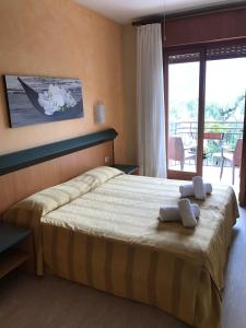 Postel nebo postele na pokoji v ubytování Hotel Smeraldo