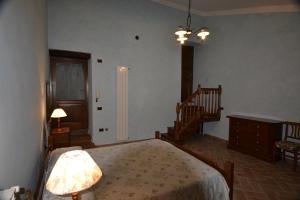 a bedroom with a bed with a lamp and a staircase at B&B FEDERICO II in Montefalco