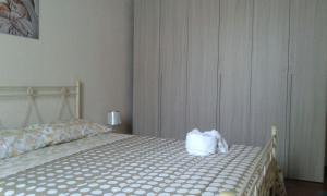 a bedroom with a bed with a towel on it at Il Baffo in Portopalo