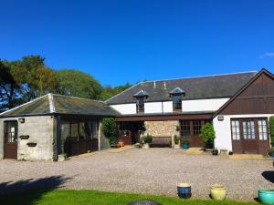 a large house with a garage and a barn at The Old Station Guest House in St Andrews