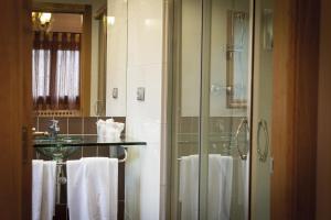 a bathroom with a shower and a sink and towels at Pensión Ametzagaña in San Sebastián +56 photos