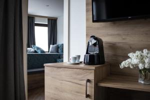 a living room with a couch and a coffee maker on a cabinet at Flussbett in Kirchberg an der Pielach