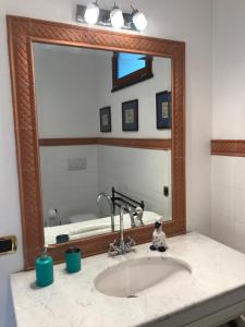 a bathroom sink with a large mirror above it at Appartamento GOLF CLUB GARLENDA - ALASSIO in Garlenda