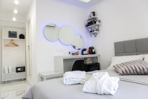 a bedroom with two beds with mirrors on the wall at Petite Palace Aristotelous 7 in Thessaloniki