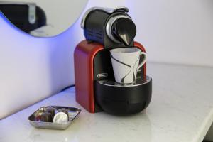 a coffee maker sitting on a counter next to a container of chocolate at Petite Palace Aristotelous 7 in Thessaloniki