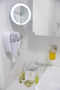 a bathroom with a sink and a mirror at Petite Palace Aristotelous 7 in Thessaloniki