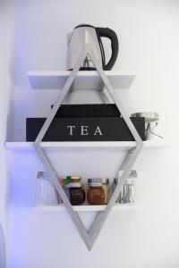 a shelf with a tea kettle on top of it at Petite Palace Aristotelous 7 in Thessaloniki