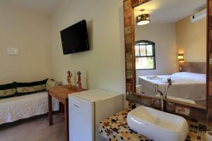 Cama ou camas em um quarto em Pousada Tupinamba