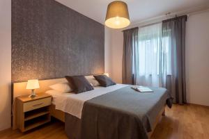 a bedroom with a large bed and a large window at Apartments Rajkovic in Labin +44 photos